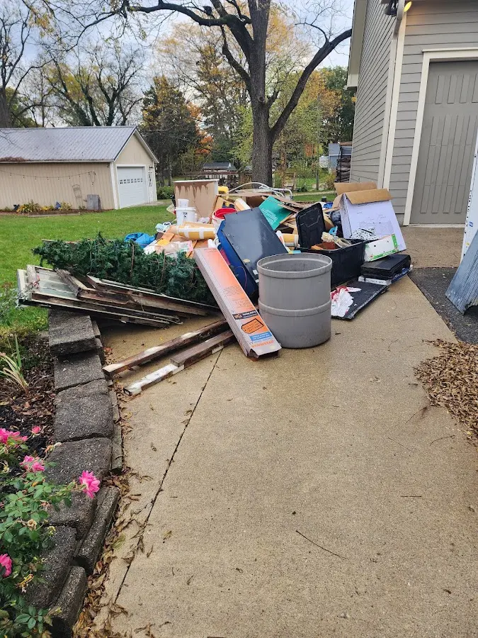 Dumpster being loaded with debris for Commercial Dumpster Rental in Clinton